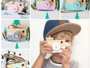 Enfant garçon qui joue avec un appareil photo en bois