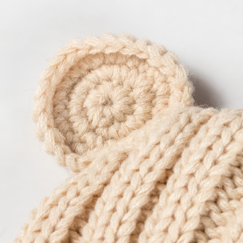 Détails du bonnet bébé beige